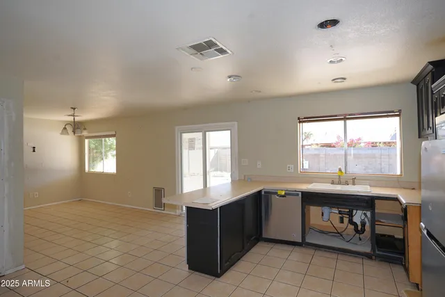a kitchen with refrigerator cabinets and wooden floor