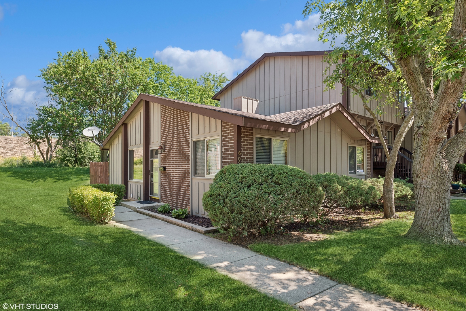 a view of a house with yard and a garden