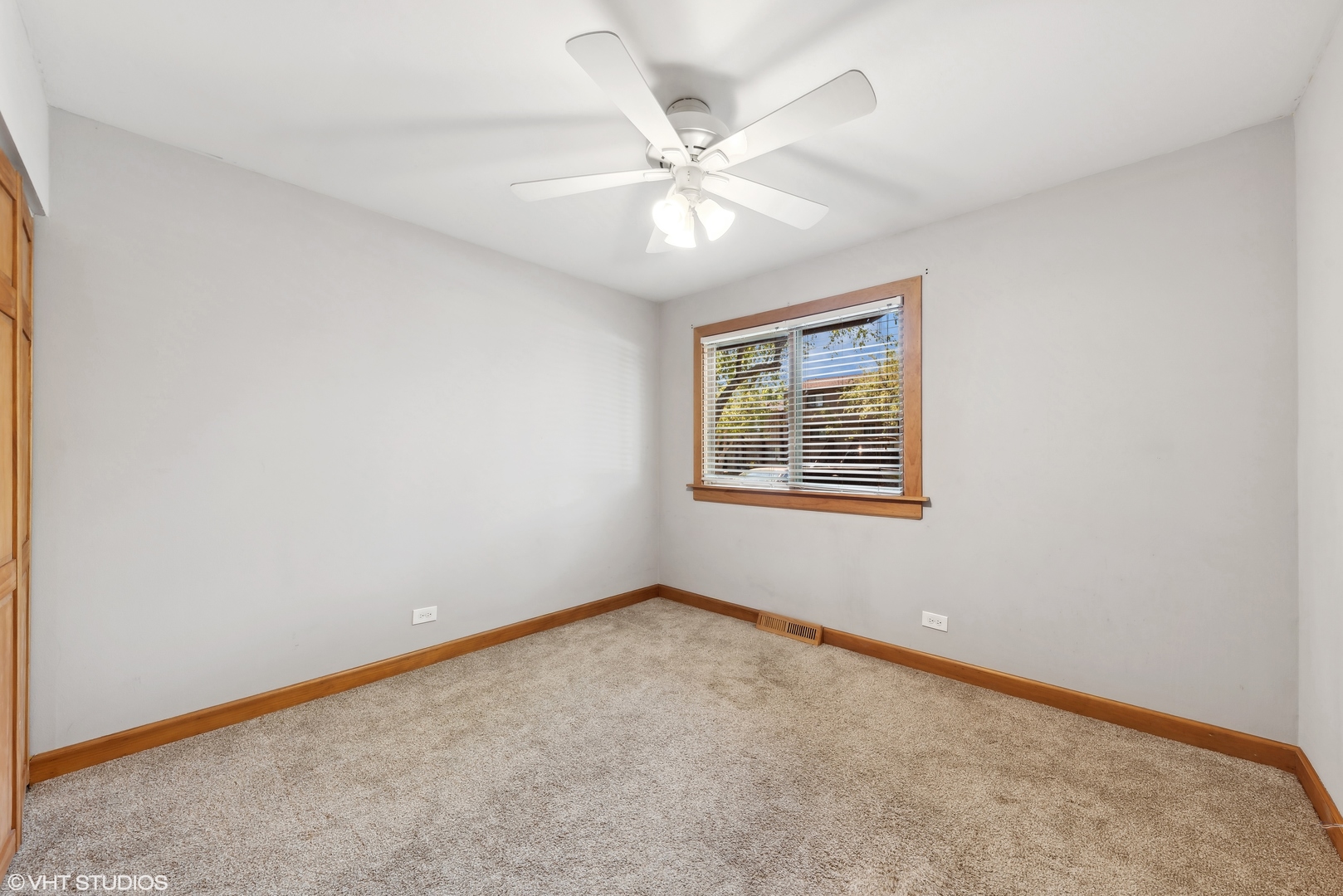602 Forum Drive Roselle, IL 60172 - Photo 11 of 15 an empty room with a window and a ceiling fan