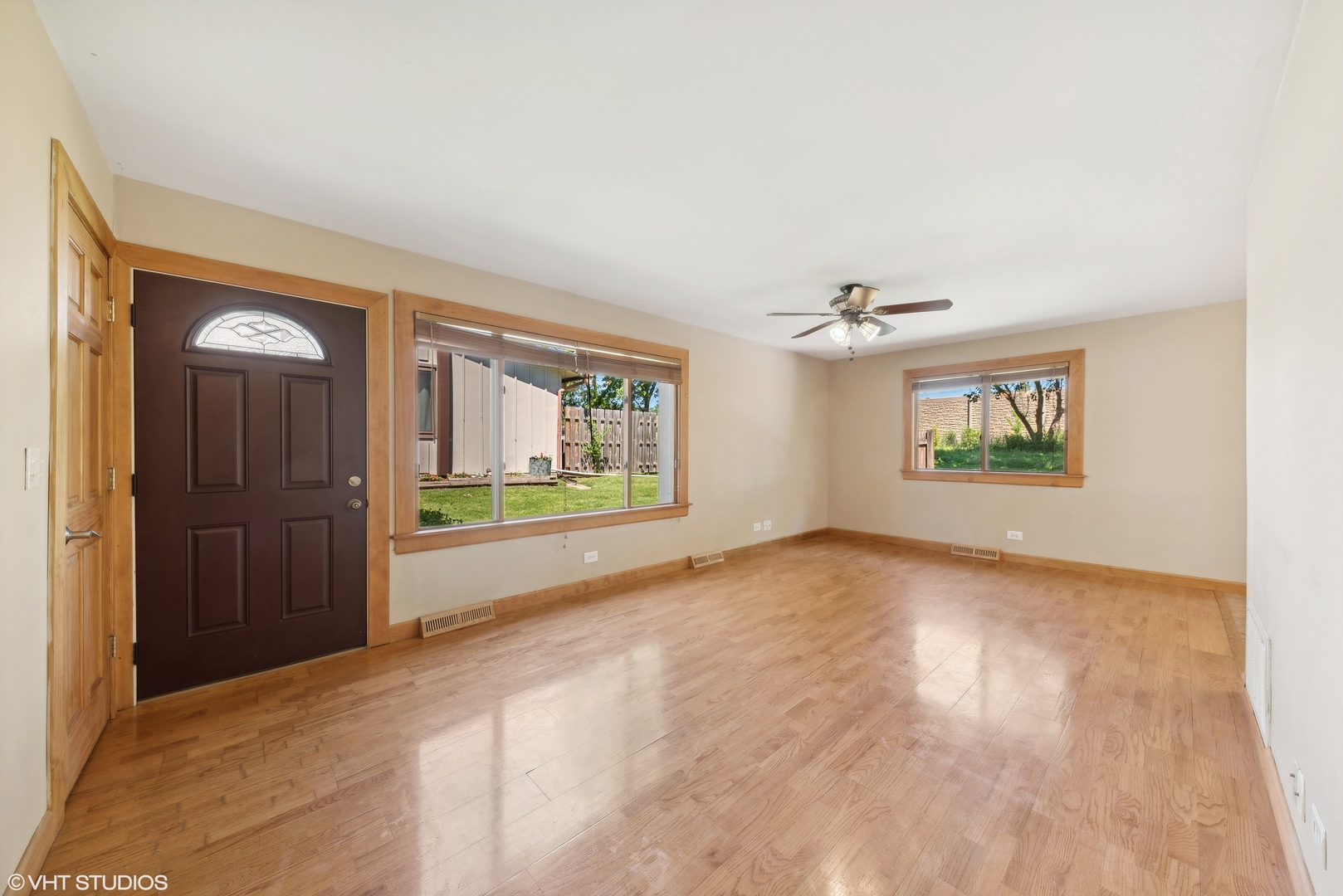 602 Forum Drive Roselle, IL 60172 - Photo 3 of 15 an empty room with windows and ceiling fan