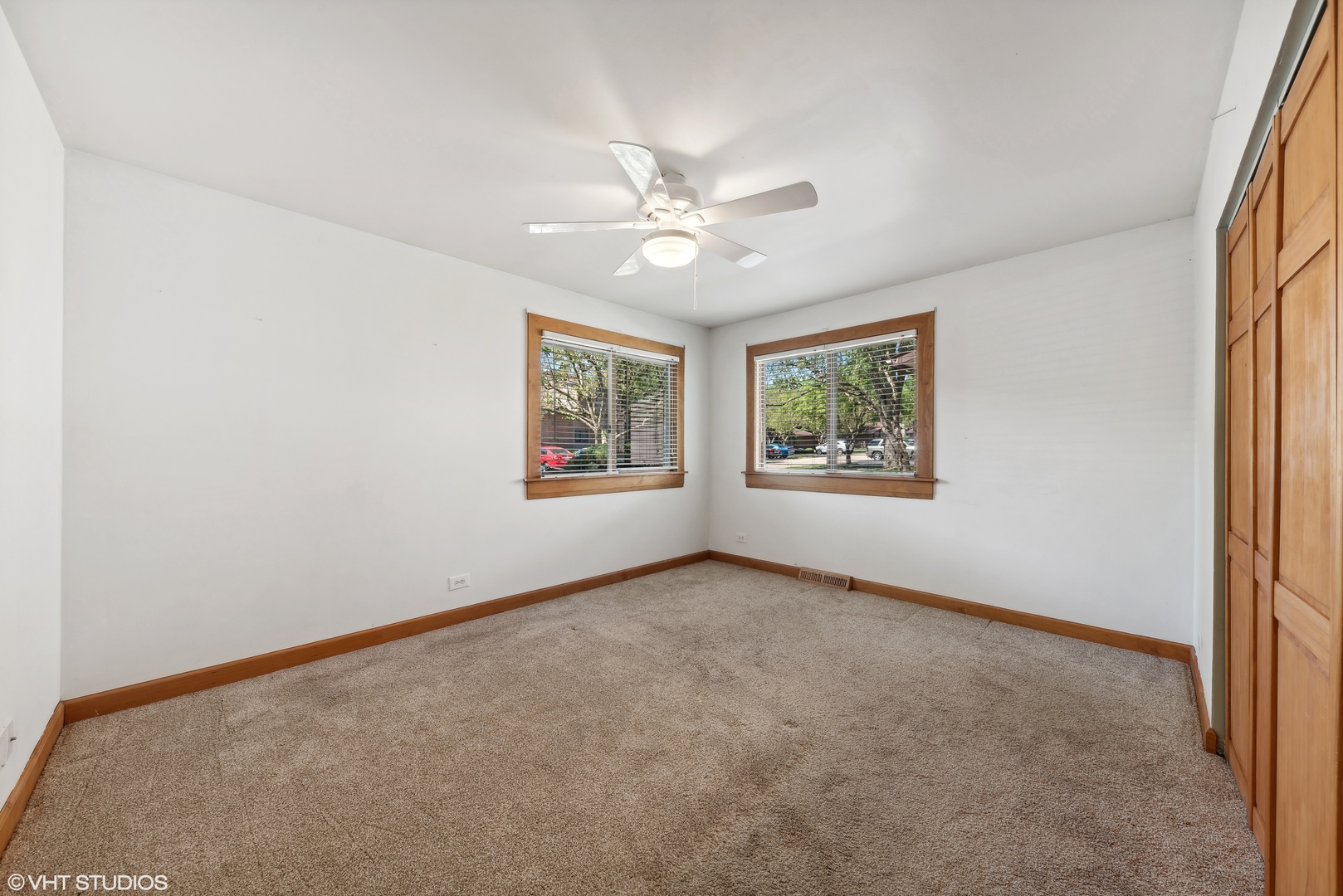 602 Forum Drive Roselle, IL 60172 - Photo 10 of 15 an empty room with windows and ceiling fan