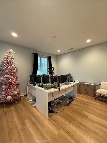 a living room with furniture and a room with gym equipment