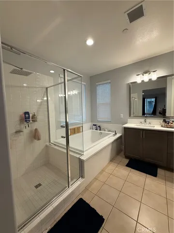 a bathroom with a double vanity sink and a mirror