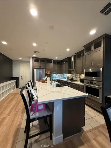 a large kitchen with a table and chairs
