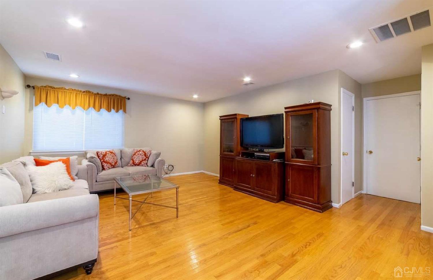 31 Lavender Drive Edison, NJ 08820 - Photo 12 of 25 a living room with furniture and a flat screen tv