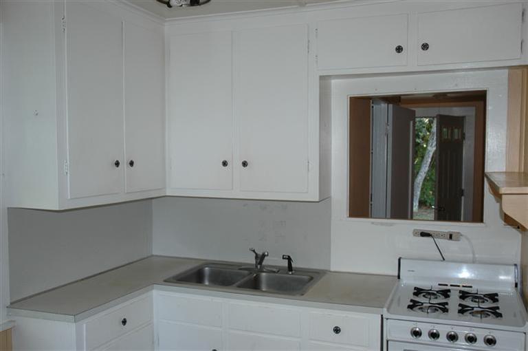143 Shore Road Bourne, MA 02532 - Photo 30 of 35 a kitchen with a sink and cabinets