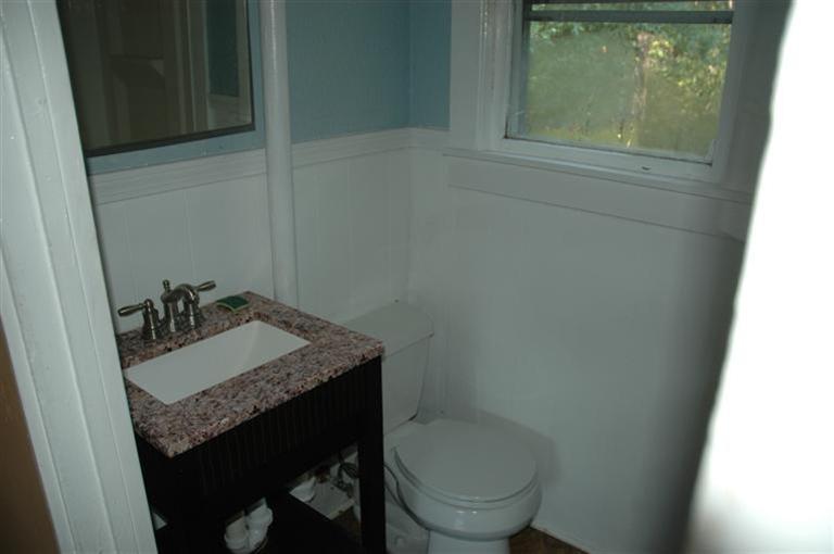 143 Shore Road Bourne, MA 02532 - Photo 31 of 35 a bathroom with a granite countertop sink and a toilet