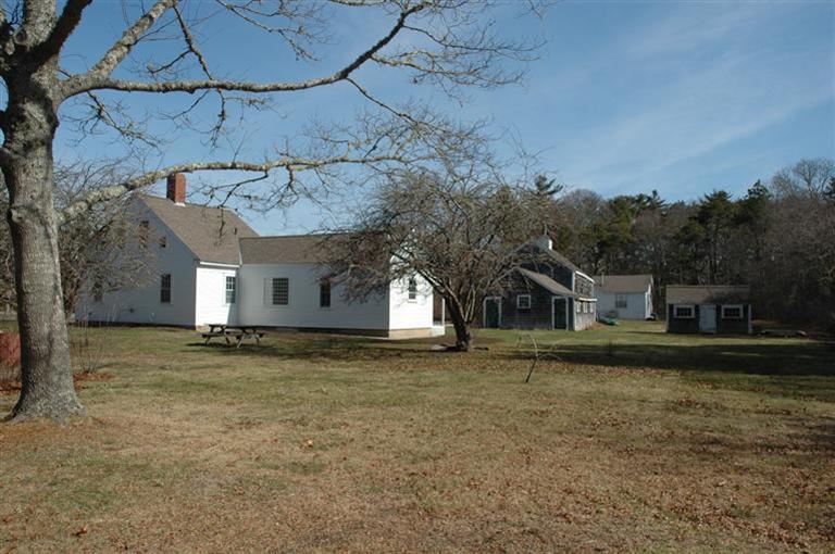 143 Shore Road Bourne, MA 02532 - Photo 33 of 35 a big house with a large tree in front of it