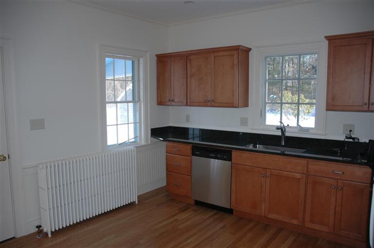 143 Shore Road Bourne, MA 02532 - Photo 6 of 35 a kitchen with granite countertop wooden cabinets a sink and dishwasher with wooden floor