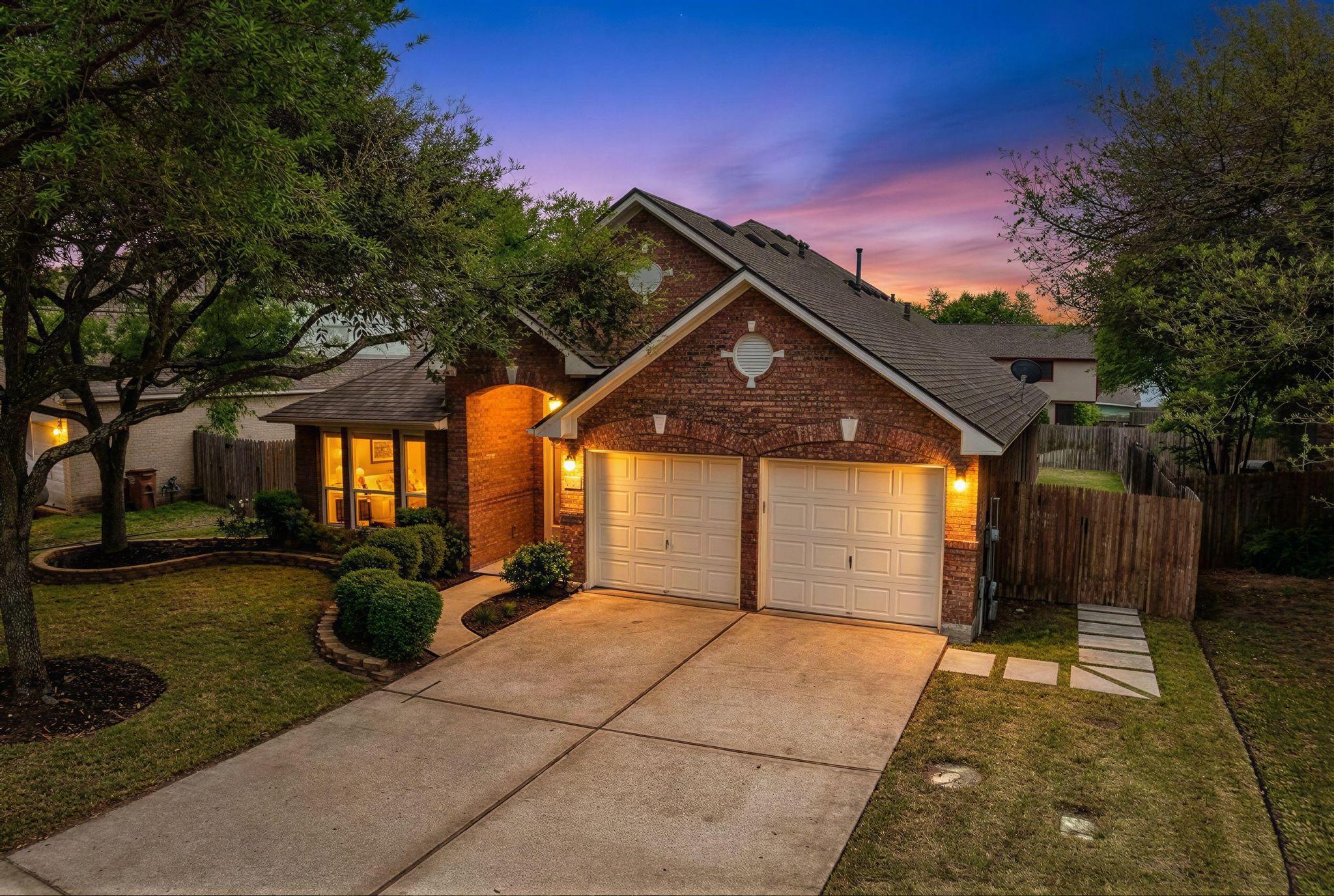 Traditional-style house featuring brick siding, concrete driveway, and an attached garage