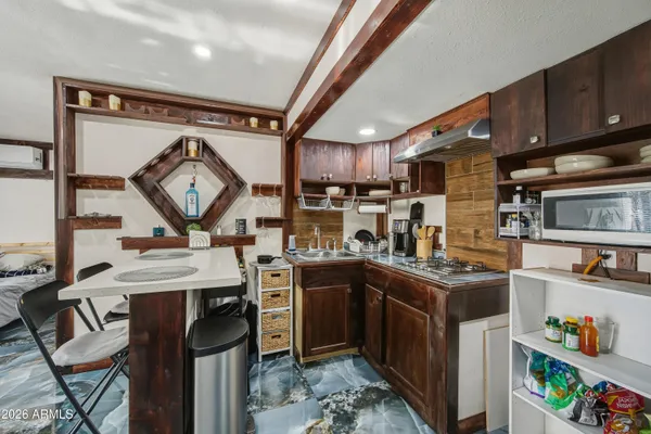 a kitchen with stainless steel appliances granite countertop a stove a sink dishwasher and cabinets with wooden floor