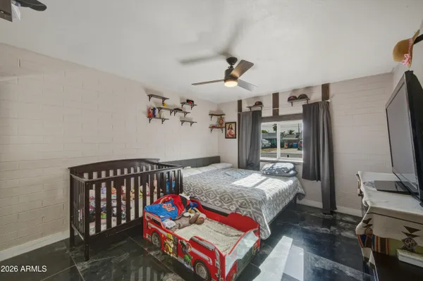 a bedroom with a bed and a flat screen tv