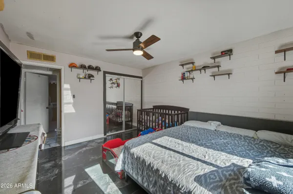 a bedroom with a bed a dresser and book shelf