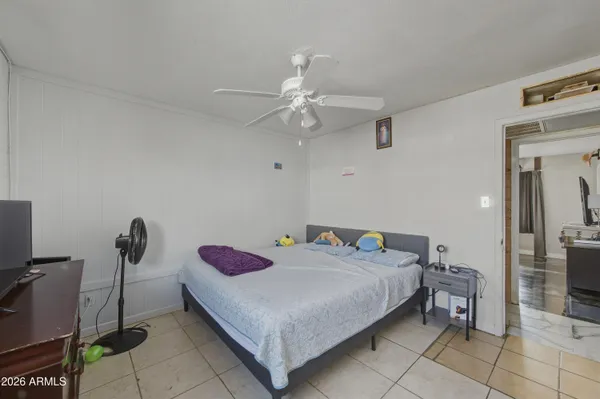 a bedroom with a bed and a chandelier