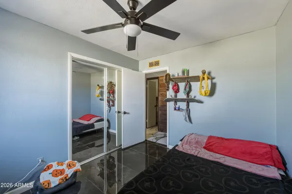 a bedroom with a bed and a chandelier