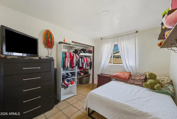 a bedroom with a bed and a flat screen tv