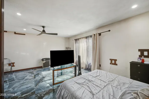 a bedroom with a bed and a flat screen tv