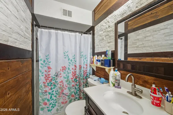 a bathroom with a sink toilet and shower