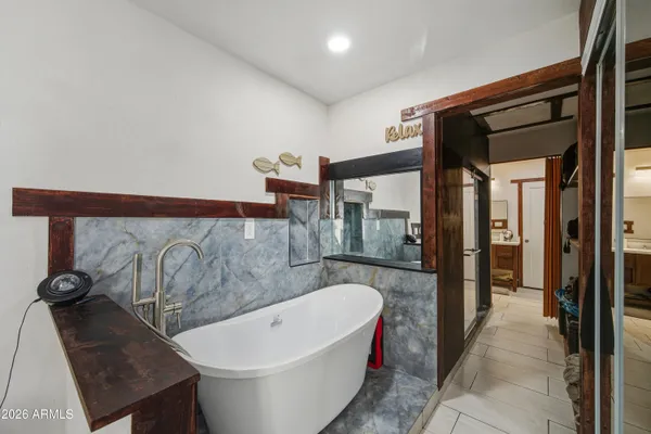 a bathroom with a bathtub and shower