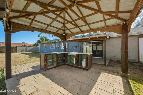 a view of a porch with furniture and a yard