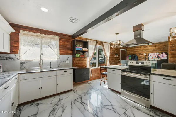 a kitchen with stainless steel appliances granite countertop a sink and cabinets