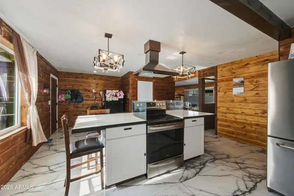 a kitchen with stainless steel appliances a stove and cabinets