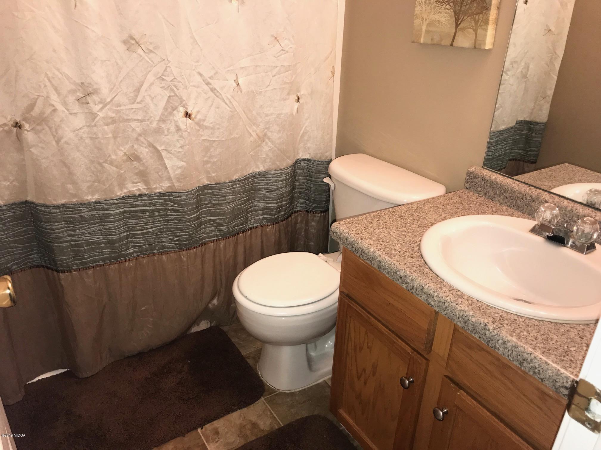 255 Autumn Ridge Court Gray, GA 31032 - Photo 14 of 16 a bathroom with a toilet and a sink