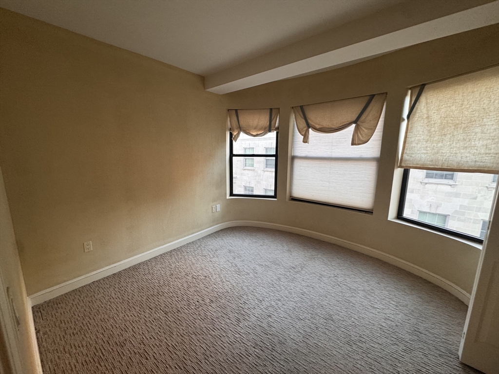 636 Beacon Street, Unit 404 Boston, MA 02215 - Photo 11 of 20 an empty room with windows and closet