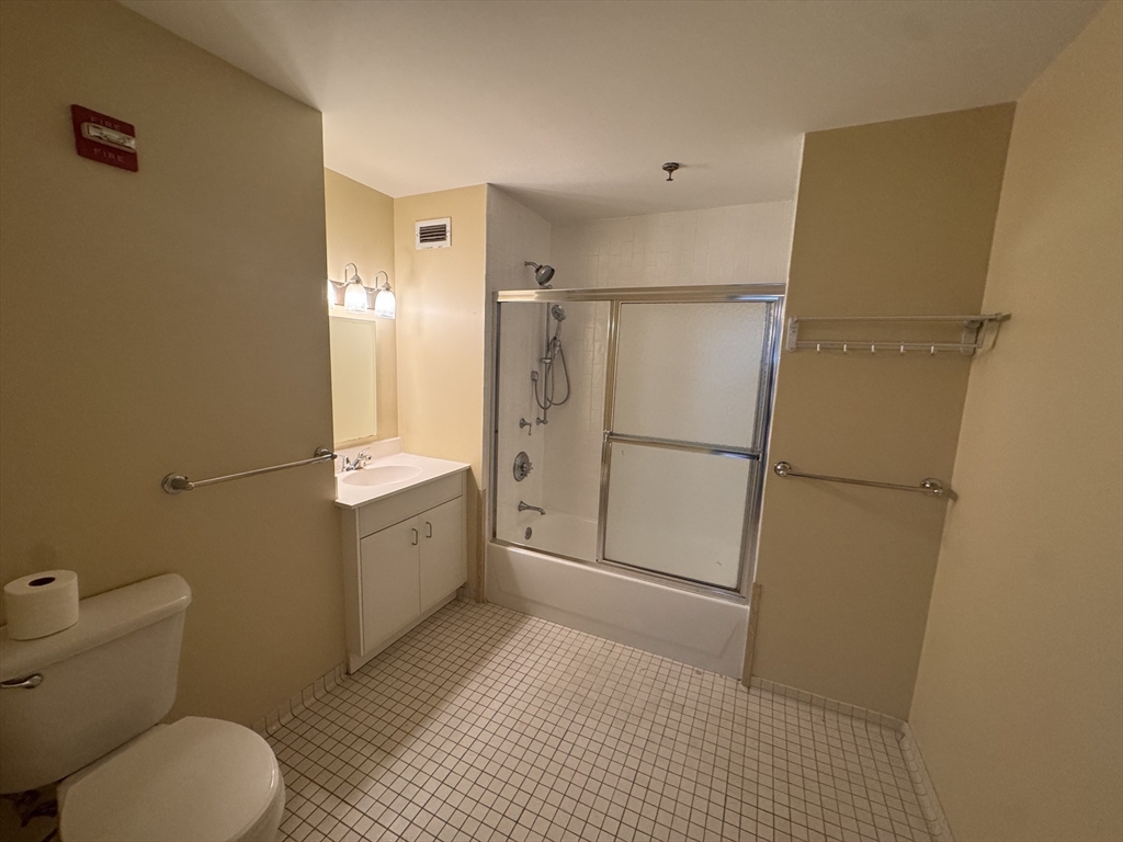 636 Beacon Street, Unit 404 Boston, MA 02215 - Photo 15 of 20 a bathroom with a granite countertop sink toilet and shower