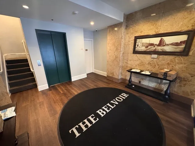 a view of a livingroom with furniture and staircase