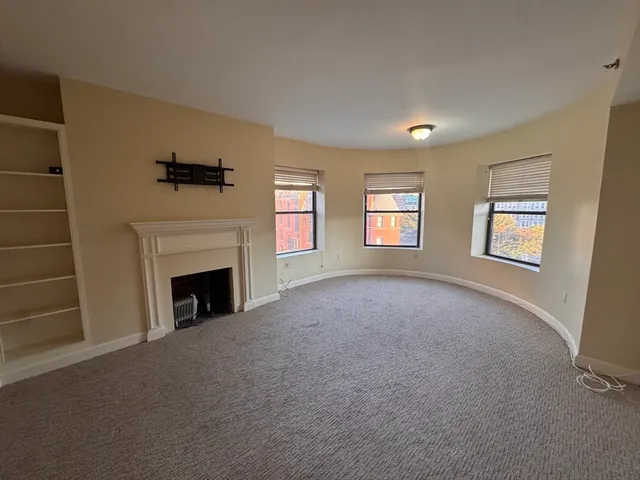 a view of empty room with a fireplace