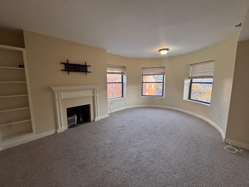 636 Beacon Street, Unit 404 Boston, MA 02215 - Photo 2 of 20 a view of empty room with a fireplace