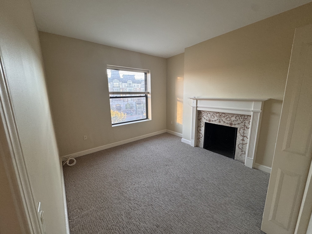 636 Beacon Street, Unit 404 Boston, MA 02215 - Photo 3 of 20 a view of empty room with a fireplace
