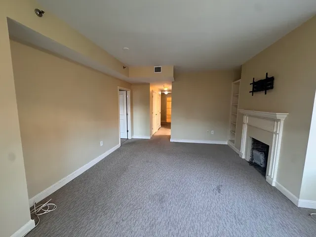 a view of empty room with a fireplace