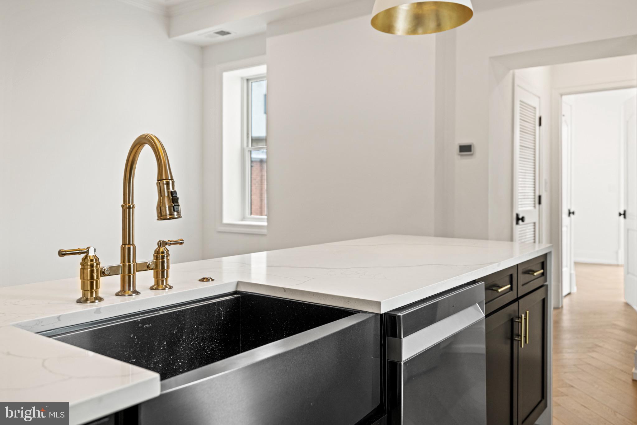 1709 21st Street Northwest, Unit 42 Washington, DC 20009 - Photo 11 of 21 a kitchen with a sink and a stove with wooden floor