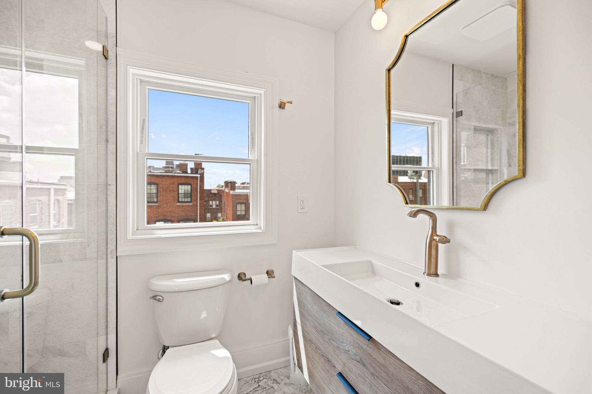 1709 21st Street Northwest, Unit 42 Washington, DC 20009 - Photo 14 of 21 a bathroom with a toilet sink a mirror and shower