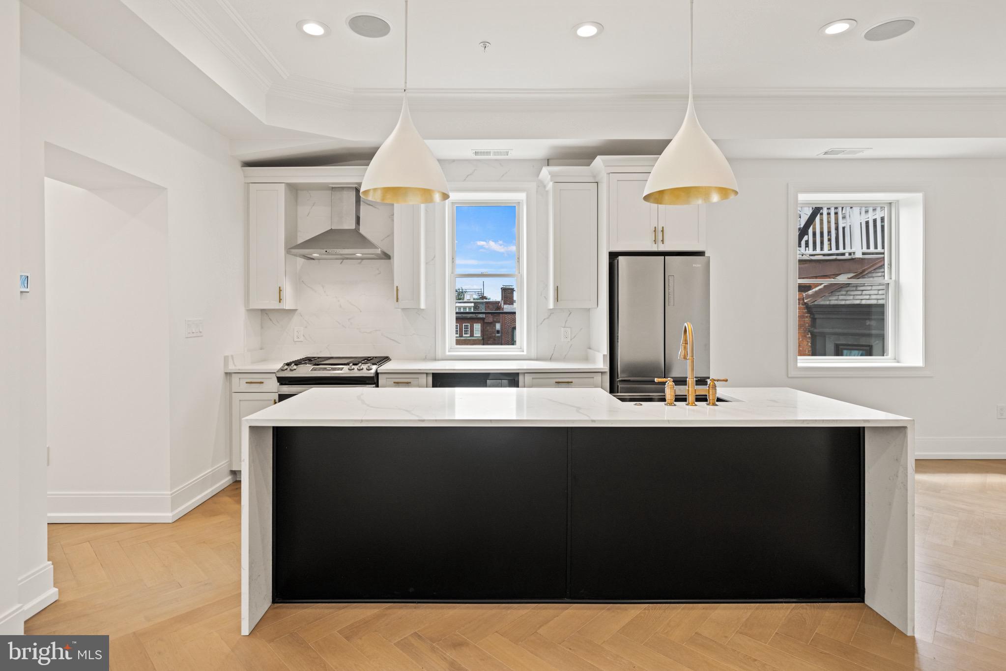 1709 21st Street Northwest, Unit 42 Washington, DC 20009 - Photo 6 of 21 a kitchen with granite countertop a sink and white cabinets