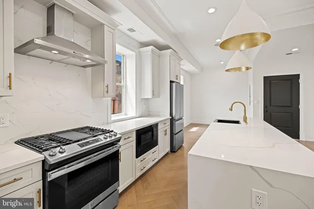 a kitchen with stainless steel appliances a stove and a refrigerator