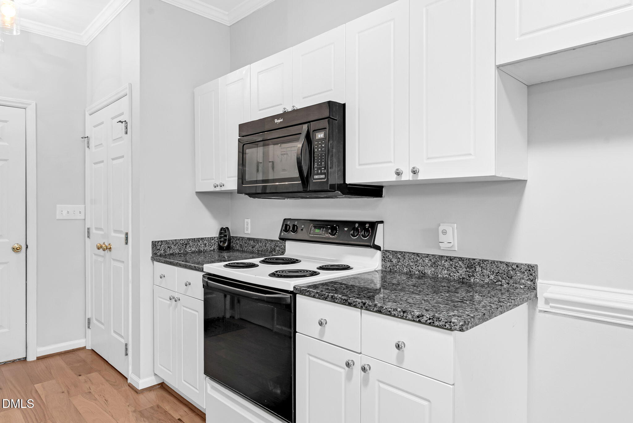 5512 Grand Traverse Drive Raleigh, NC 27604 - Photo 16 of 62 a kitchen with granite countertop a stove sink and microwave