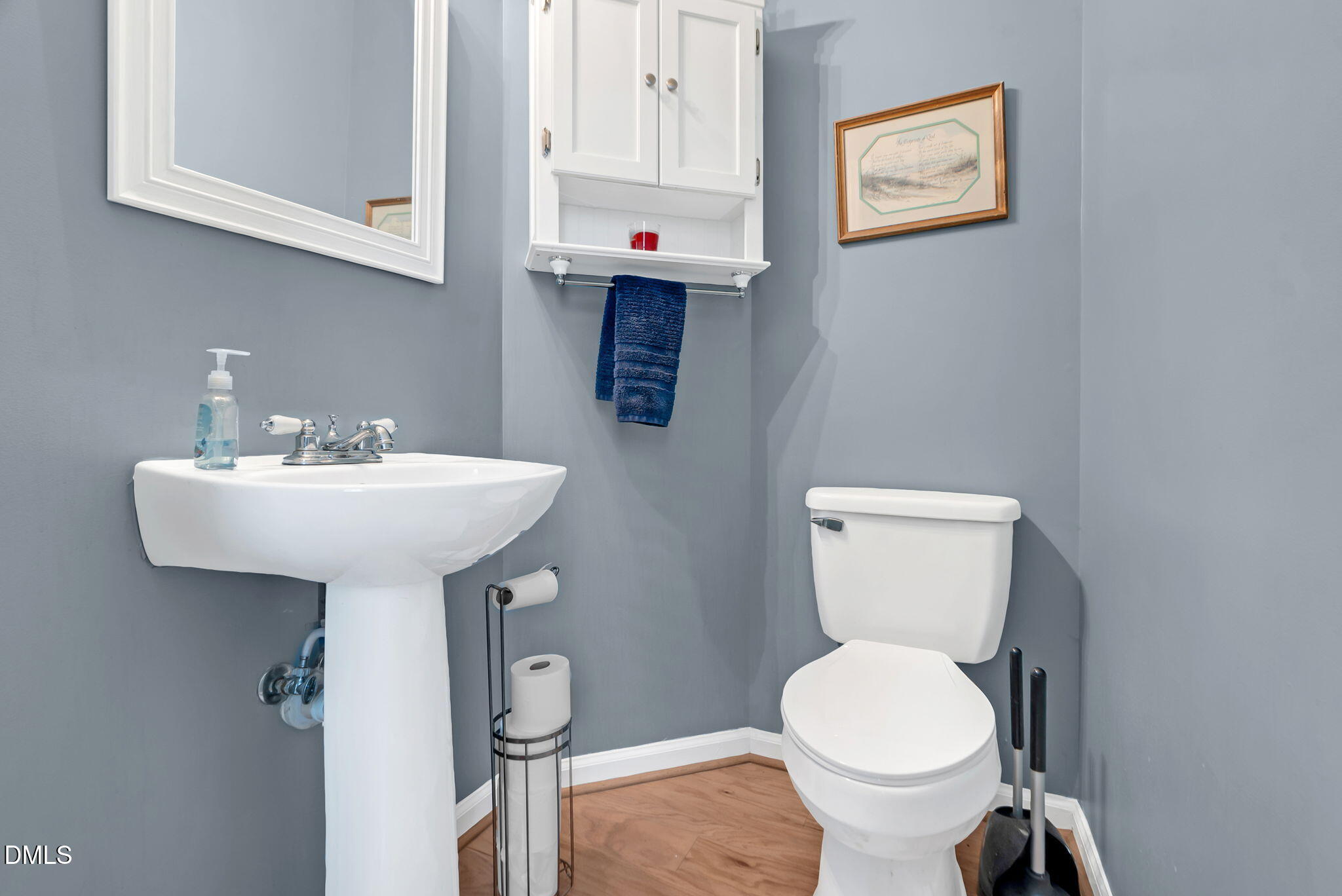 5512 Grand Traverse Drive Raleigh, NC 27604 - Photo 22 of 62 a bathroom with a toilet sink and mirror