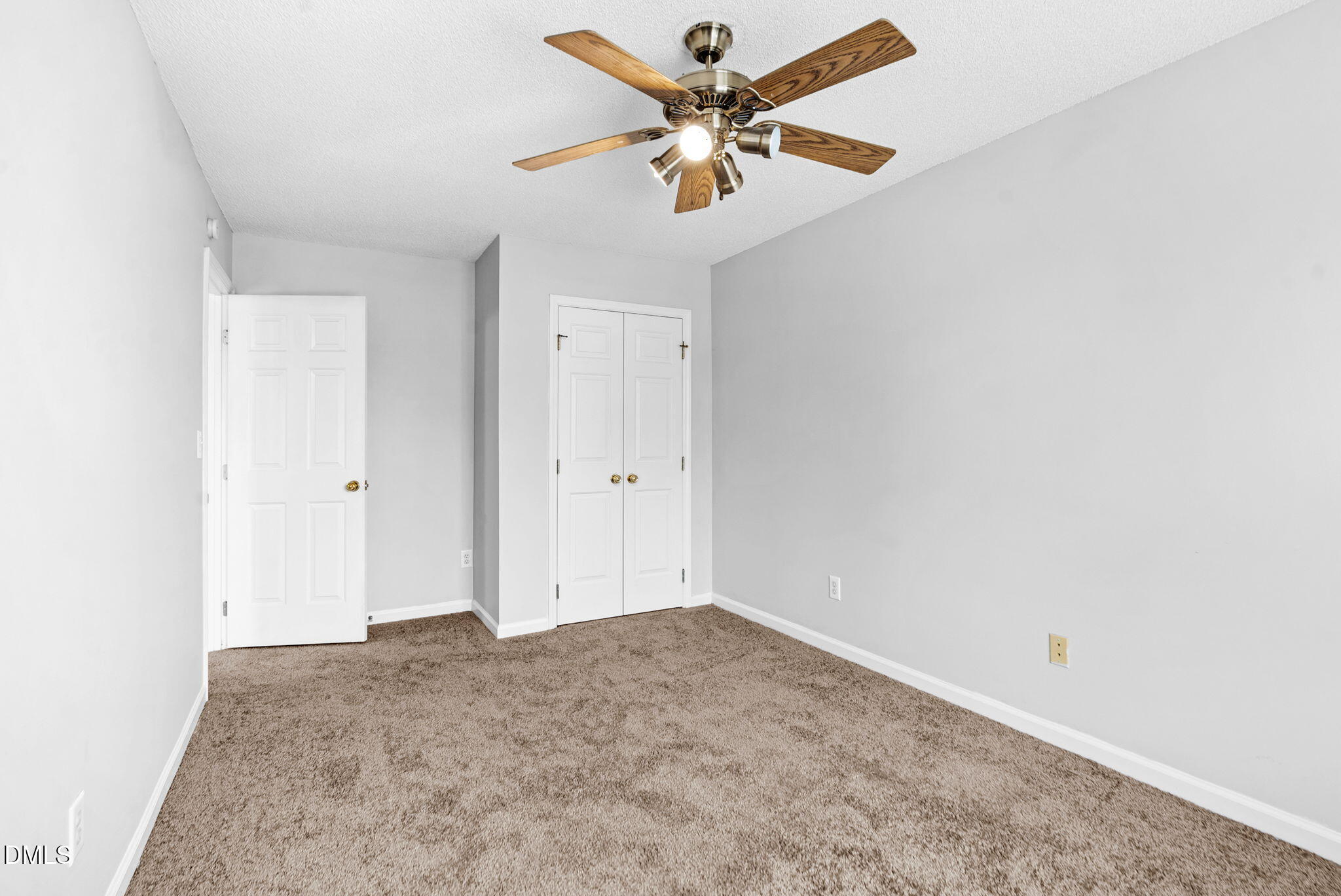 5512 Grand Traverse Drive Raleigh, NC 27604 - Photo 25 of 62 an empty room with a ceiling fan and a window