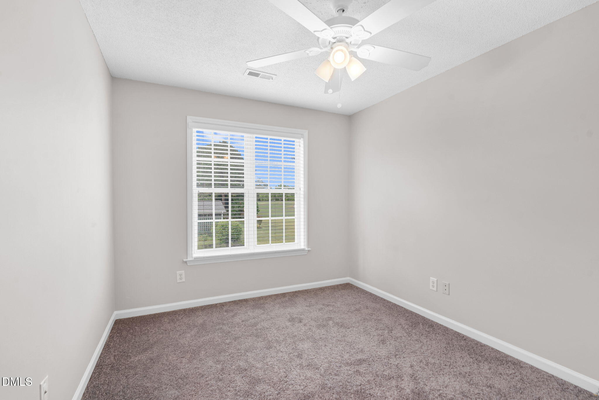 5512 Grand Traverse Drive Raleigh, NC 27604 - Photo 26 of 62 an empty room with a window and a fan