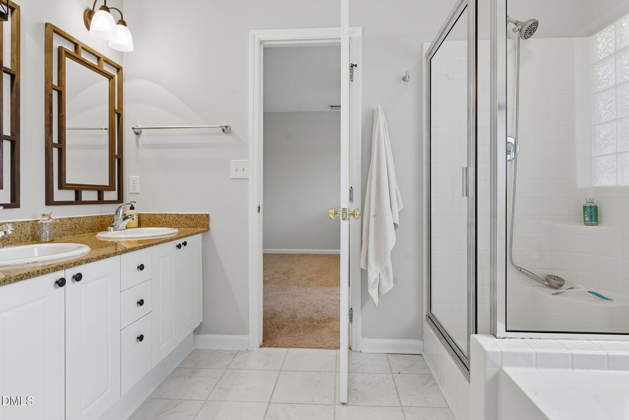 5512 Grand Traverse Drive Raleigh, NC 27604 - Photo 32 of 62 a bathroom with a double vanity sink and a mirror