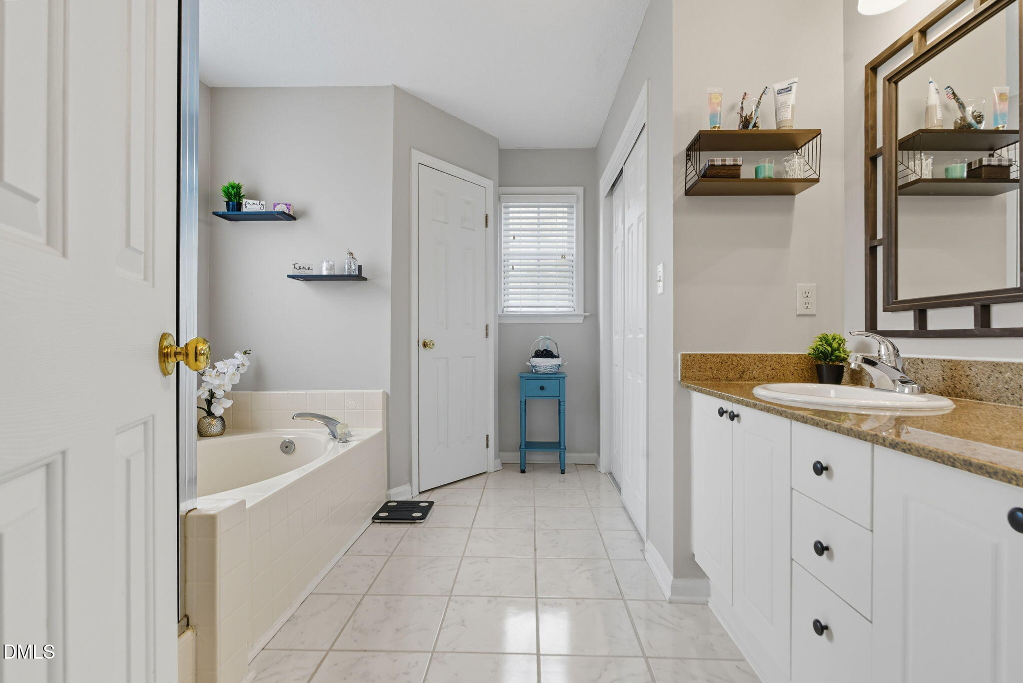5512 Grand Traverse Drive Raleigh, NC 27604 - Photo 33 of 62 a bathroom with a tub sink and mirror