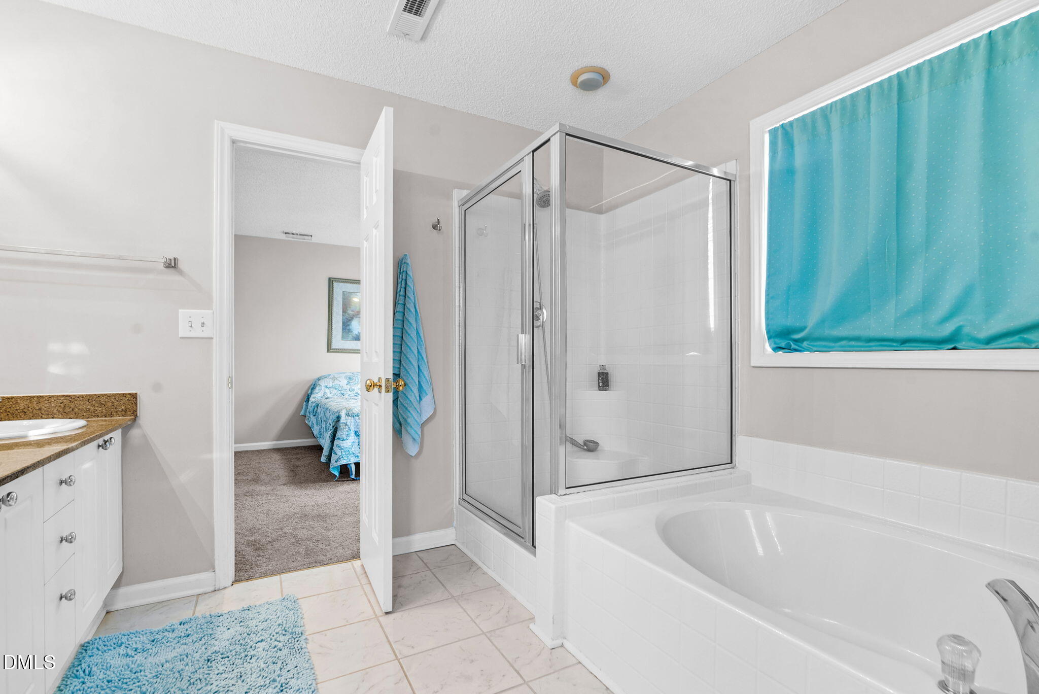 5512 Grand Traverse Drive Raleigh, NC 27604 - Photo 35 of 62 a bathroom with a tub a sink and a shower