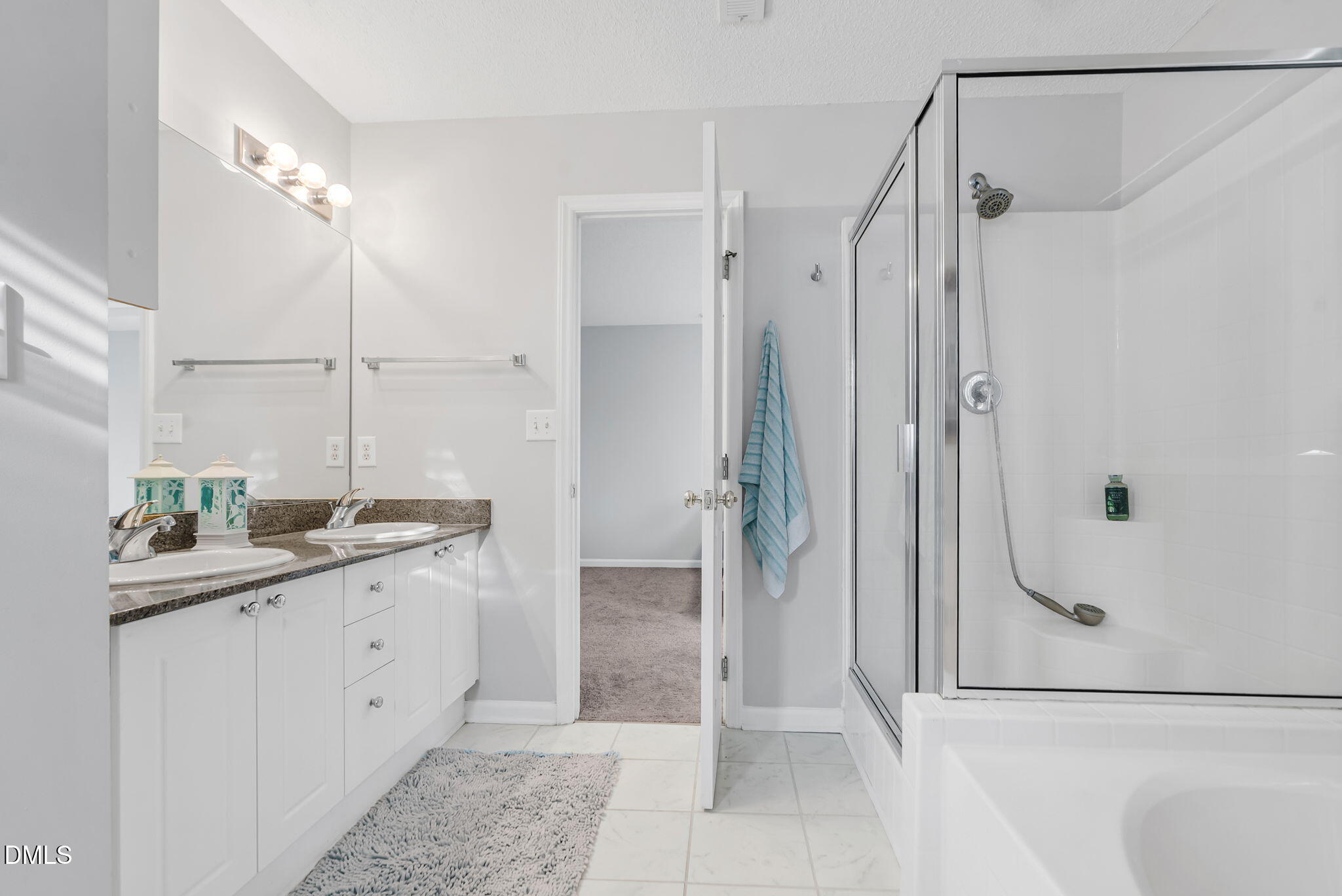 5512 Grand Traverse Drive Raleigh, NC 27604 - Photo 36 of 62 a bathroom with a granite countertop sink a shower and a mirror