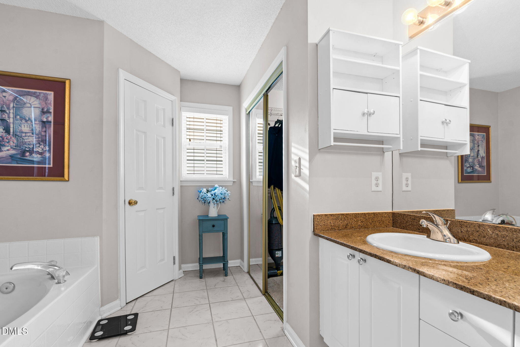5512 Grand Traverse Drive Raleigh, NC 27604 - Photo 37 of 62 a bathroom with a sink and a mirror