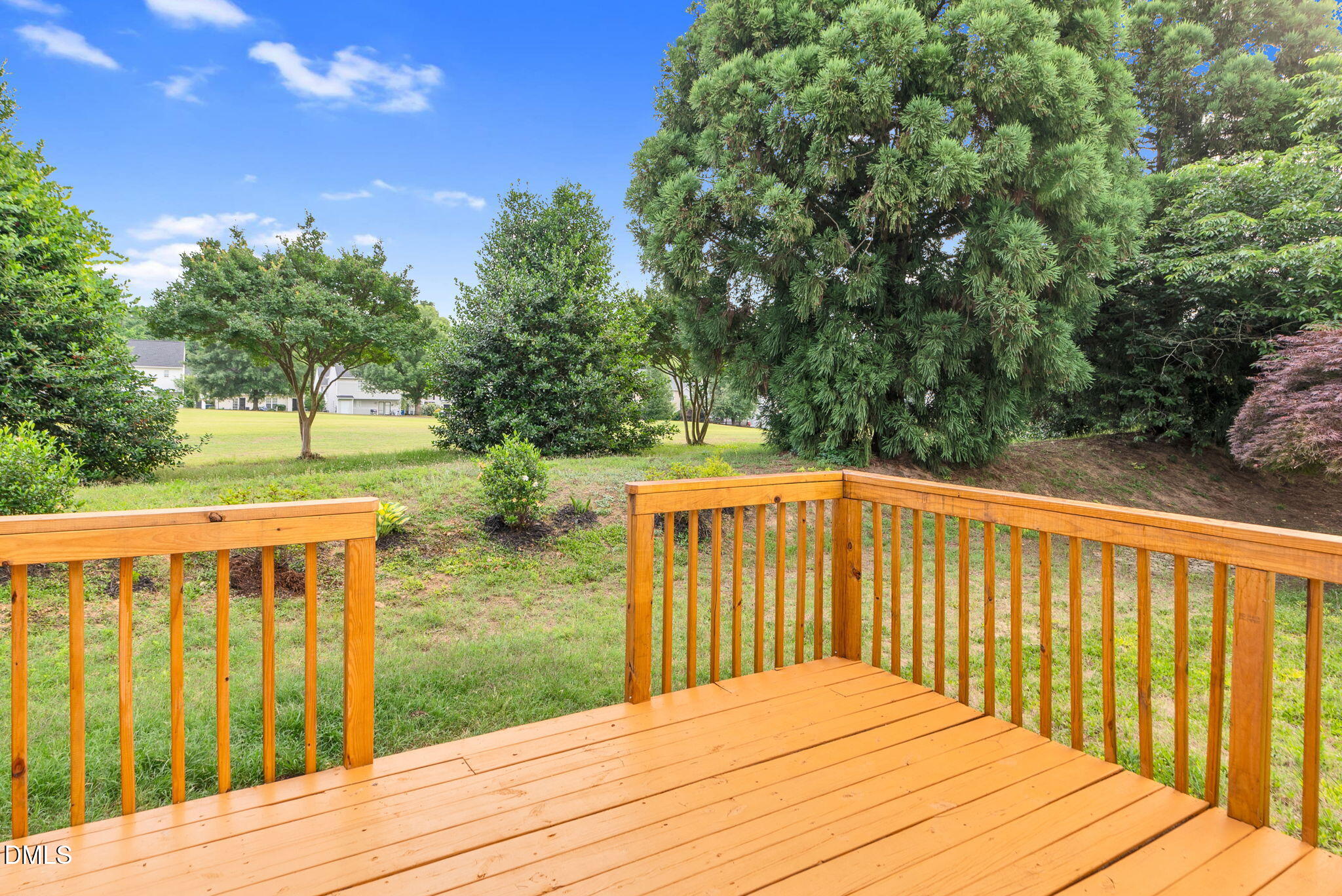 5512 Grand Traverse Drive Raleigh, NC 27604 - Photo 44 of 62 a balcony with wooden floor and yard in the back