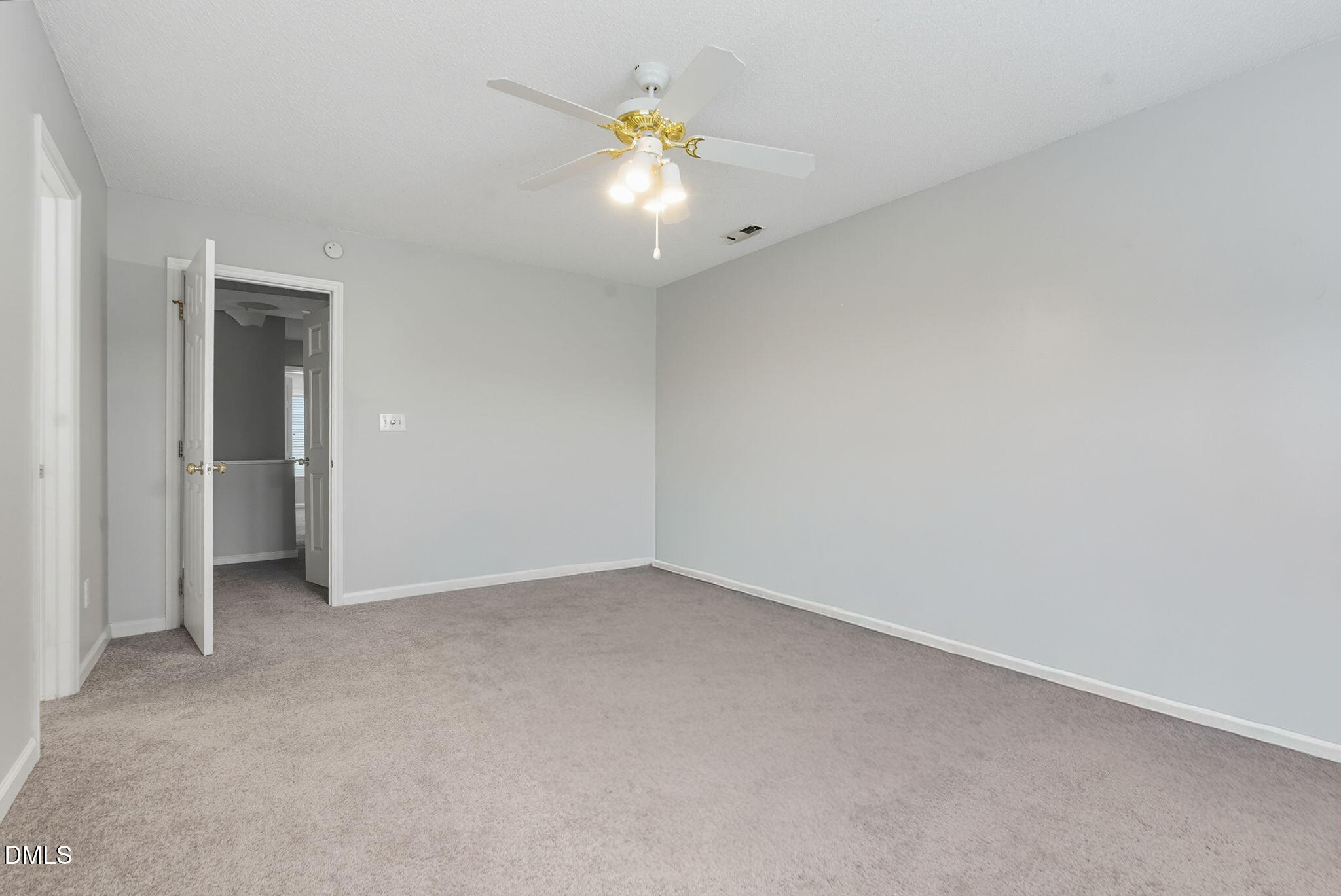 5512 Grand Traverse Drive Raleigh, NC 27604 - Photo 5 of 62 an empty room with a ceiling fan and bathroom