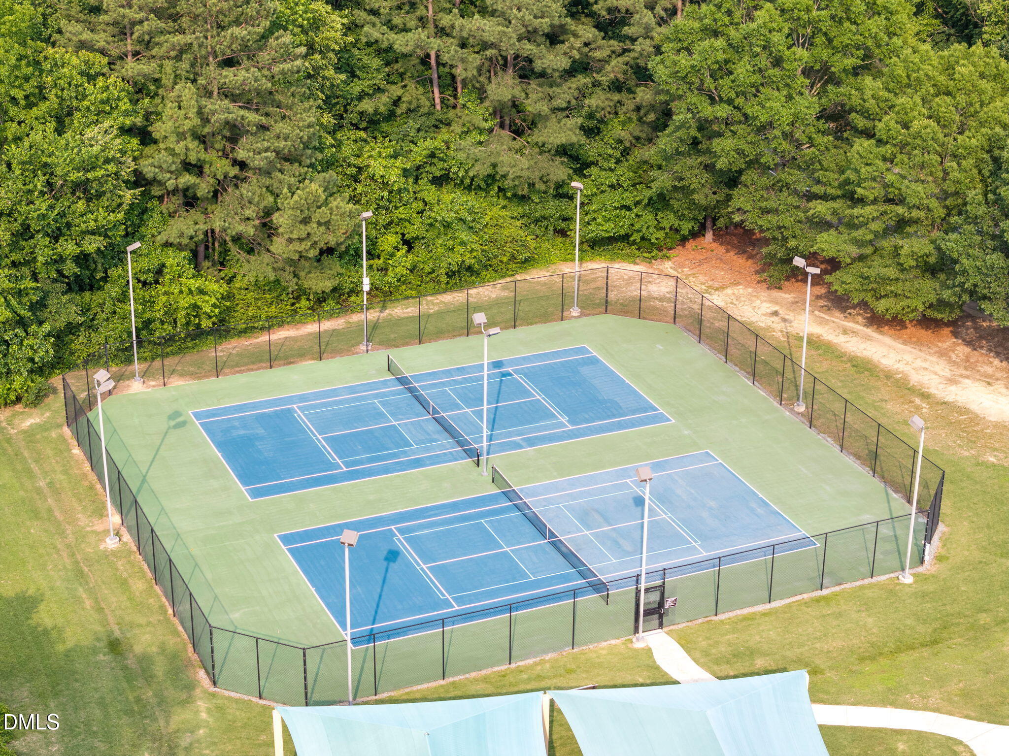 5512 Grand Traverse Drive Raleigh, NC 27604 - Photo 51 of 62 a view of a tennis ground with large trees